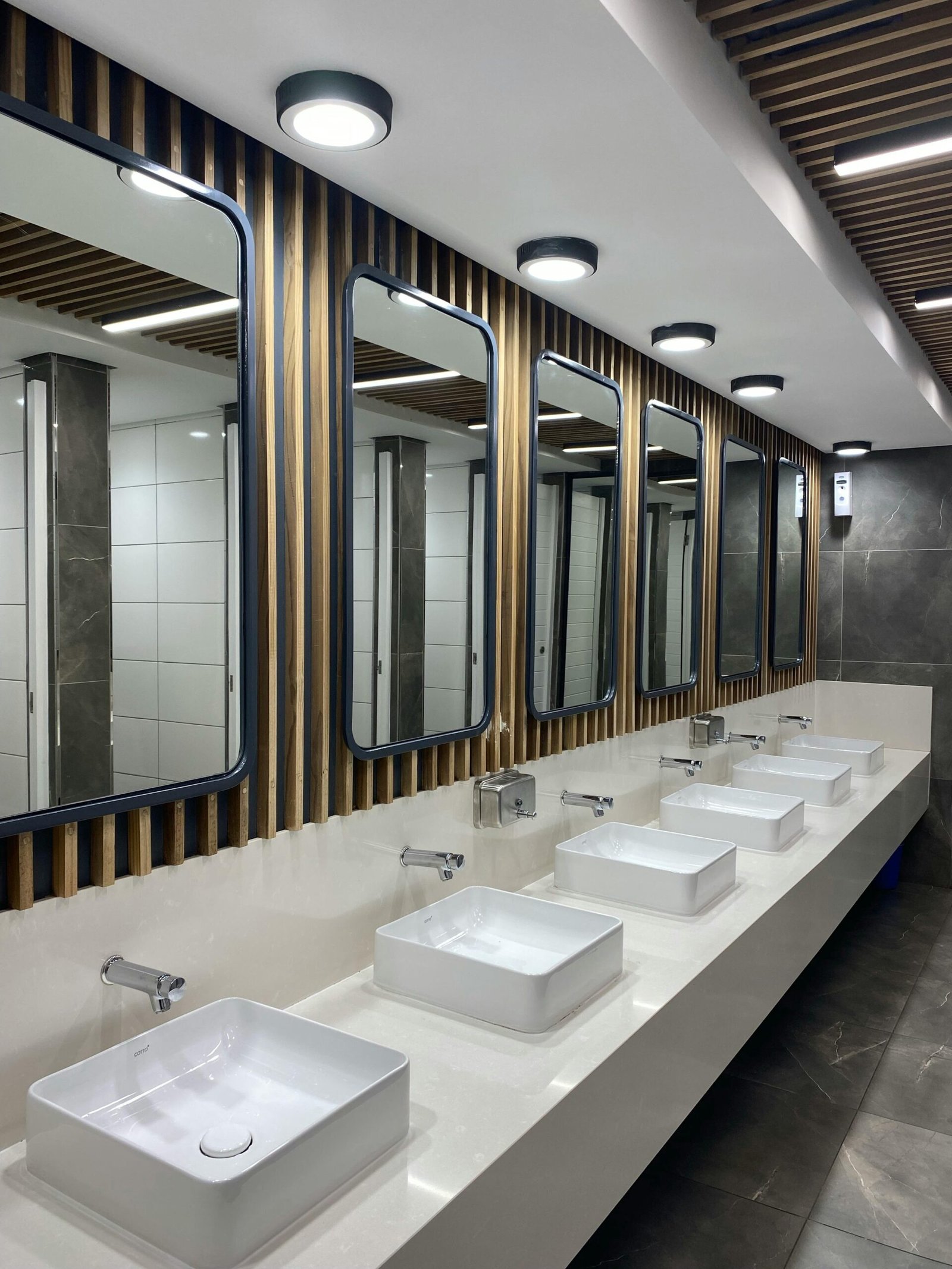 Contemporary and stylish restroom with sinks, mirrors, and lighting.